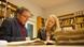 Karin Helmstaedt and historian Walter Rummel in a library