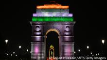 A statue of India's independence hero Subhas Chandra Bose (C) is pictured through India Gate, illuminated with the colours of the Indian flag, after the recent inauguration of the newly renovated avenue Central Vista in New Delhi on September 10, 2022. (Photo by Sajjad HUSSAIN / AFP) (Photo by SAJJAD HUSSAIN/AFP via Getty Images)