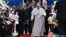 Pope Francis walks surrounded by wellwishers after he arrived on April 28, 2023 at the Liszt Ferenc airport in Budapest for his second visit to Hungary in less than two years. - The Pope will meet refugees, believers, students, church and state leaders during his tree-day trip and celebrates a holy mass in front of the parliament building, at the Kossuth Square of Budapest on Sunday morning. (Photo by Vincenzo PINTO / AFP) (Photo by VINCENZO PINTO/AFP via Getty Images)