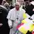 Pope Francis (C) is greeted by children waving flags after he arrived on April 28, 2023 at the Liszt Ferenc airport in Budapest.
