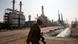 An Iranian oil worker makes his way through Tehran's oil refinery south of the capital Tehran, Iran, Monday, Dec. 22, 2014