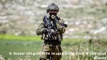 April 28, 2023, Nablus, West Bank, Palestine: An Israeli soldier seen holding his weapon as he guards against Palestinian protesters, during the demonstration against Israeli settlements in the village of Beit Dajan near the West Bank city of Nablus. (Credit Image: © Nasser Ishtayeh/SOPA Images via ZUMA Press Wire