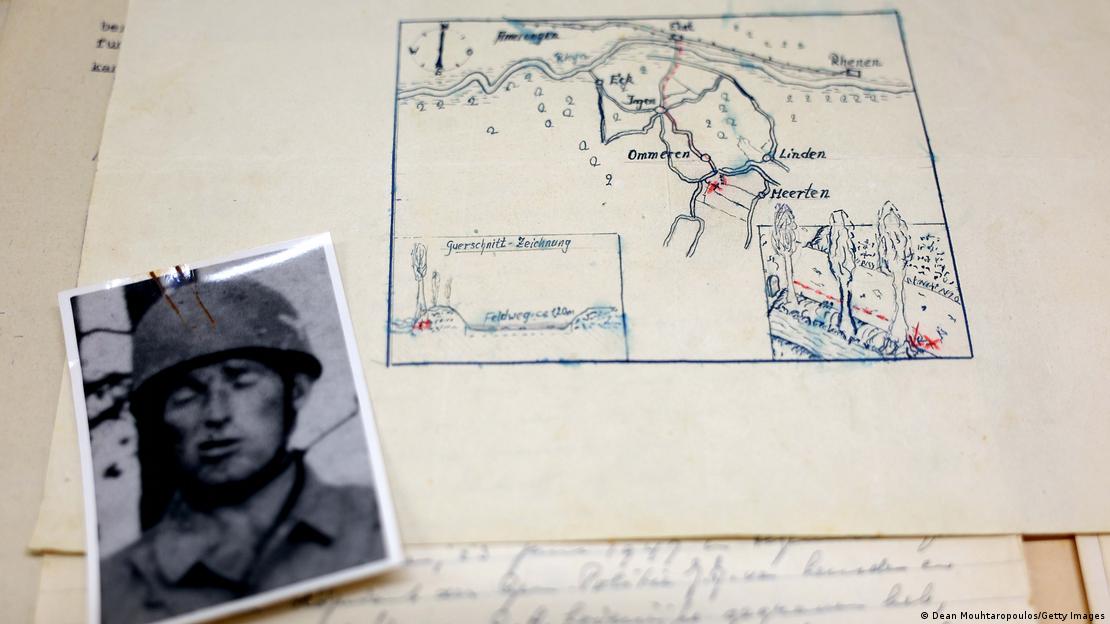 A detailed view of the collection of information including photos, letters, statements and the map accompanied by a photo of a German soldier
