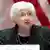 A closeup of US Treasury Secretary Janet Yellen at a podium with an American flag in the background