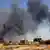 Smoke rises above buildings after aerial bombardment in Khartoum North, Sudan
