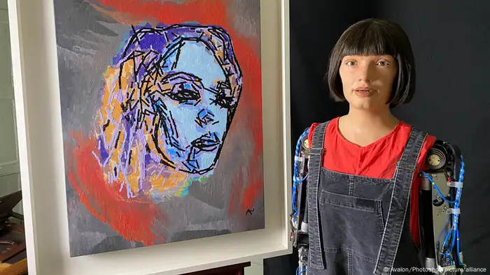 A humanoid robot alongside a painting