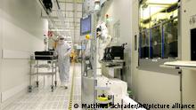 An employee walks through a clean room of German semiconductor manufacturer Infineon in Regensburg, southern Germany, on Tuesday, Jan. 29, 2013. Infineon Technologies AG, headquarter in Neubiberg near Munich, offers semiconductors and systems for automotive, industrial, and multimarket sectors, as well as chipcard and security products. (AP Photo/Matthias Schrader)