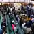 Ugandan members of parliament stand as they participate in the vote