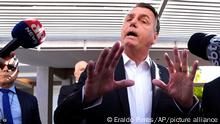 Former Brazilian President Jair Bolsonaro speaks to the press outside his home after Federal Police agents carried out a search and seizure warrant in Brasilia, Brazil, Wednesday, May 3, 2023. When asked about the search of Bolsonaro’s home in Brasilia, the Federal Police press office gave a statement saying officers were carrying out searches and arrests related to the introduction of fraudulent data related to the COVID-19 vaccine into the nation’s health system. (AP Photo/Eraldo Peres)