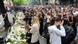 People gather to pay tribute near the school where a mass shooting was carried out by a teenager who killed fellow students and staff in Belgrade, Serbia