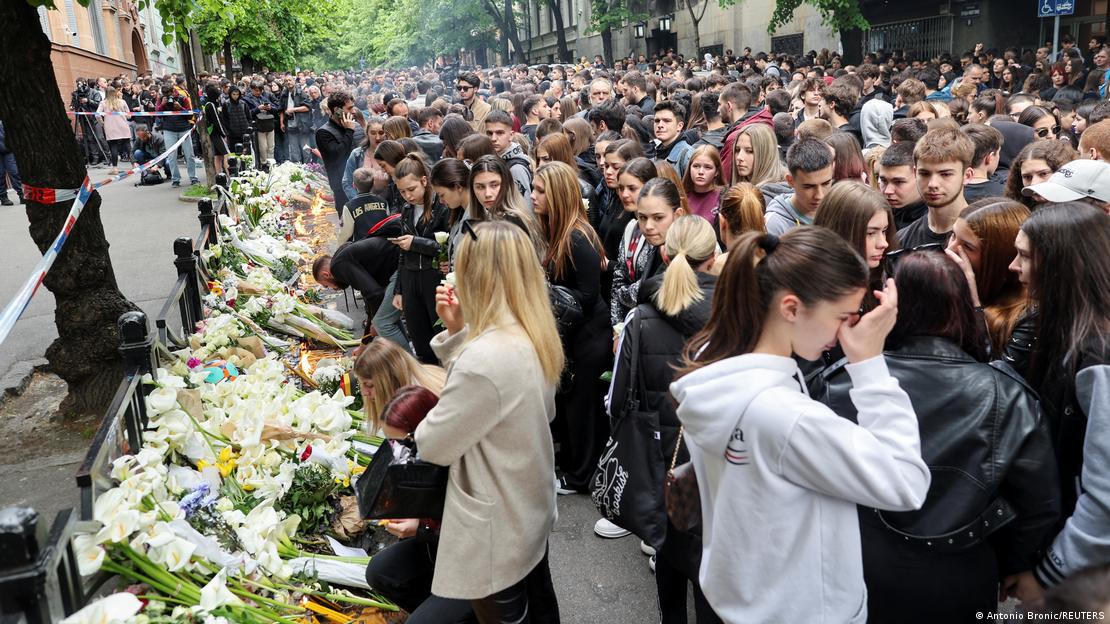 People gather to pay tribute near the school where a mass shooting was carried out by a teenager who killed fellow students and staff in Belgrade, Serbia