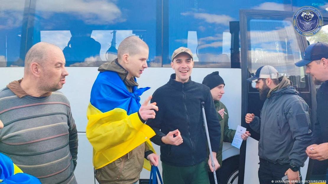 Young men in front of a bus