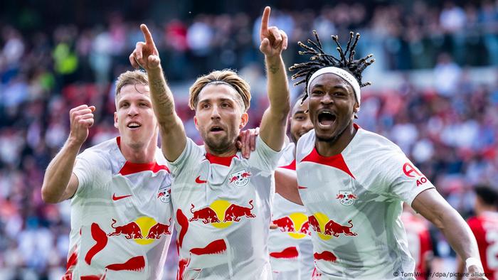 Leipzigs Kevin Kampl (M) jubelt mit seinen Teamkollegen Daniel Olmo Carvajal (l) und Mohamed Simakan (r).