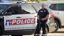 A law enforcement officer guards the entrance to a shopping center after a shooting Saturday, May 6, 2023, in Allen, Texas. (AP Photo/LM Otero)
