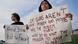 Protesters hold signs at a vigil after the May 6 shooting in Texas Protesters hold signs at a vigil after the May 6 shooting in Texas