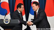 South Korean President Yoon Suk Yeol shakes hands with Japanese Prime Minister Fumio Kishida during a joint press conference after their meeting at the presidential office in Seoul on May 7, 2023. Jung Yeon-je/Pool via REUTERS