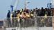Migrants waiting to disembark from a ship Migrants waiting to disembark from a ship