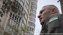 Kyiv Mayor Vitali Klitschko stands in front of an apartment building damaged by a drone that was shot down during a Russian overnight strike, amid Russia's attack, in Kyiv, Ukraine, Monday, May 8, 2023. (AP Photo/Andrew Kravchenko)