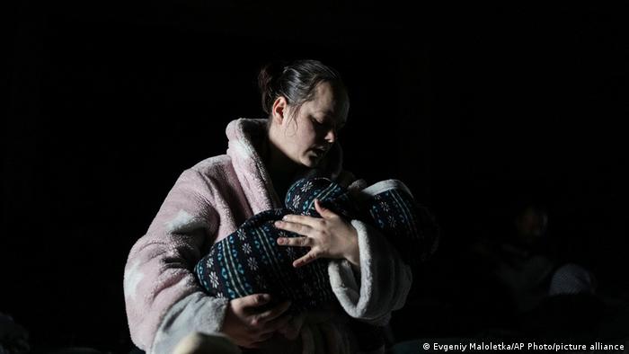 Una mujer sostiene a su bebé en brazos en Mariupol