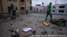 Palestinian paramedics inspect damage in a building following Israeli airstrikes on an apartment of an Islamic Jihad commander in Gaza City, Tuesday, May 9, 2023. The Israeli military says it has killed three senior commanders of the militant Islamic Jihad group in targeted airstrikes. Palestinian health officials said 13 people were killed in total in Tuesday's attacks, including the commanders, their wives, several of their children and others nearby. (AP Photo/Fatima Shbair)