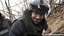 (FILES) AFP journalist Arman Soldin, walks in a trench as he is covering the war in Ukraine on March 18, 2023. Arman was killed by a rocket strike as he reported with AFP colleagues from Ukrainian positions in Chasiv Yar on May 9, 2023. Arman, who was 32 and born in Bosnia, began his career as an AFP intern in the Rome bureau before moving to London in 2015. He was formally appointed as Ukraine video coordinator for AFP based in Kyiv in September 2022. Arman's death is a terrible reminder of the risks and dangers of covering this war. Our thoughts tonight are with his family and friends, and with all AFP people on the ground in Ukraine. (Photo by Aris MESSINIS / AFP)