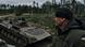 A Ukrainian soldier looks at a passing APC close to the Russian positions A Ukrainian soldier looks at a passing APC close to the Russian positions