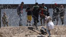 TOPSHOT - Migrant people cross the banks of the Rio Grande to be processed by the Border Patrol El Paso Sector, Texas, after crossing from Ciudad Juarez, Mexico on May 8, 2023. - Mexican President Andres Manuel Lopez Obrador said Monday that he would discuss migration policy with his US counterpart Joe Biden ahead of the lifting of pandemic-era border restrictions this week. The video call on Tuesday would cover migration, fentanyl and development cooperation, Lopez Obrador told reporters, as the two countries brace for a possible wave of migrants at their shared border. (Photo by HERIKA MARTINEZ / AFP) (Photo by HERIKA MARTINEZ/AFP via Getty Images)