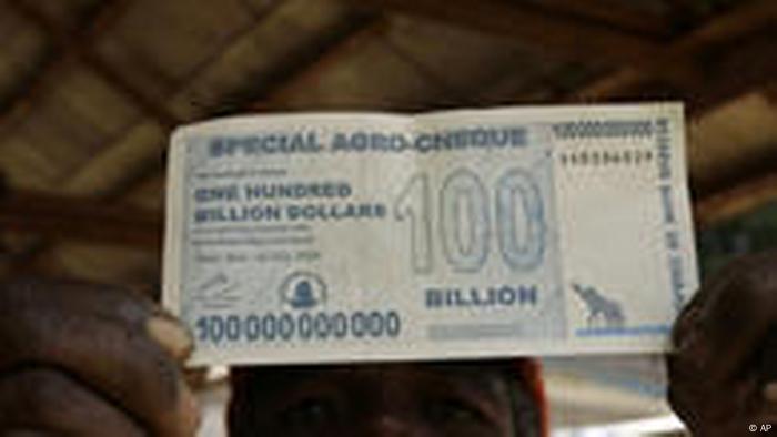 An unidentified man holds the new 100 billion dollar note introduced by the Reserve Bank of Zimbabwe.