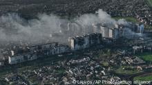 Smoke rises from buildings in this aerial view of Bakhmut, the site of the heaviest battles with the Russian troops in the Donetsk region, Ukraine, Wednesday, April 26, 2023. (AP Photo/Libkos)