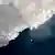 Wassertropfen fällt im Sonnenlicht von einem schmelzenden Stück Eis. Grönland schmelzender Eisberg