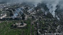 Smoke rises from buildings in this aerial view of Bakhmut, the site of the heaviest battles with the Russian troops in the Donetsk region, Ukraine, Wednesday, April 26, 2023. (AP Photo/Libkos)