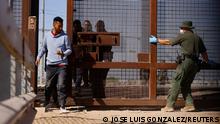 A U.S. Border Patrol agent opens a gate in the border wall for migrants who crossed the U.S.-Mexico border to enter to be processed for their immigration claim, as the U.S. prepares to lift COVID-19 era Title 42 restrictions that have blocked migrants at the border from seeking asylum since 2020, in El Paso, Texas, U.S., May 10, 2023. REUTERS/Jose Luis Gonzalez