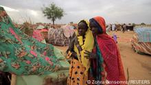 May 11, 2023. Nadia, a Sudanese refugee girl who has fled the violence in Sudan's Darfur region, hugs her freind Khadidja, beside makeshift shelters near the border between Sudan and Chad in Koufroun, Chad May 11, 2023. REUTERS/Zohra Bensemra