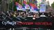 Demonstrators hold Serbian flags and a banner reading "Serbia against violence" as they march Demonstrators hold Serbian flags and a banner reading "Serbia against violence" as they march