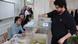 A man places his vote in a clear box as election officials look on A man places his vote in a clear box as election officials look on
