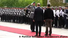 14.05.2023**A German officer salutes Germany's Chancellor Olaf Scholz, center, and Ukraine's President Volodymyr Zelenskyy, center right, during an official reception with military honors at the chancellery in Berlin, Germany, Sunday, May 14, 2023. Ukrainian President Volodymyr Zelenskyy arrived in Berlin early Sunday for talks with German leaders about further arms deliveries to help his country fend off the Russian invasion and rebuild what's been destroyed by more than a year of devastating conflict. (AP Photo/Matthias Schrader)