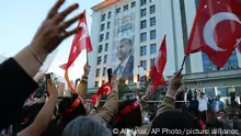 Supporters of Turkish President Recep Tayyip Erdogan's ruling party gather at the party headquarters, in Ankara, Turkey, Sunday, May 14, 2023. Election polls have closed Sunday in Turkey, where President Erdogan's leadership hung in the balance after a strong challenge from an opposition candidate. (AP Photo/Ali Unal )