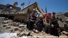 Members of the Nabhan family, including three sisters with special needs, sit in front of the ruins of their home, which was destroyed in an Israeli airstrike in Jabaliya, northern Gaza Strip, Sunday, May 14, 2023. The airstrike left 42 members of the extended family homeless. It also left four children with special needs without their wheelchairs, crutches and medical equipment needed to move about. Israel says the building was used as a command center by the Islamic Jihad militant group. The two sides reached a cease-fire Saturday to end five days of fighting. (AP Photo/Fatima Shbair)