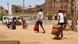 People with bags and suitcases head toward a van in Khartoum, Sudan People with bags and suitcases head toward a van in Khartoum, Sudan