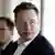 Elon Musk looks away from the camera.