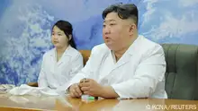 North Korean leader Kim Jong Un and his daughter Kim Ju Ae meet with members of the Non-permanent Satellite Launch Preparatory Committee, as he inspects the country's first military reconnaissance satellite, in Pyongyang, North Korea May 16, 2023, in this image released by North Korea's Korean Central News Agency on May 17, 2023. KCNA via REUTERS ATTENTION EDITORS - THIS IMAGE WAS PROVIDED BY A THIRD PARTY. REUTERS IS UNABLE TO INDEPENDENTLY VERIFY THIS IMAGE. NO THIRD PARTY SALES. SOUTH KOREA OUT. NO COMMERCIAL OR EDITORIAL SALES IN SOUTH KOREA.