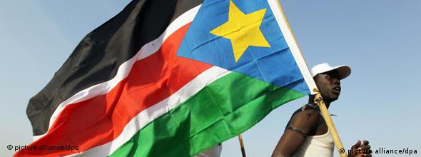 A man carrying a South Sudanese flag