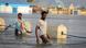 Men walk through floodwaters on a street in the town of Beledweyne Men walk through floodwaters on a street in the town of Beledweyne