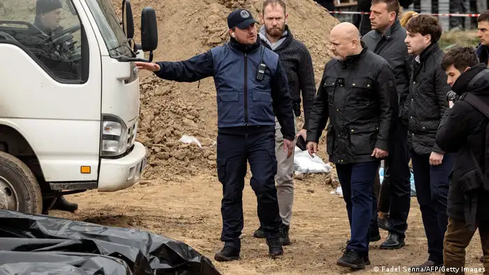 Prosecutor of the International Criminal Court, Britain's Karim Khan, visits a mass grave in Bucha, on the outskirts of Kyiv, on April 13, 2022.