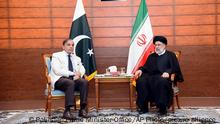 In this photo released by Pakistan Prime Minister Office, Pakistan's Prime Minister Shahbaz Sharif, left, and Iran's President Ebrahim Raisi meet during an inauguration of the Mand-Pishin border in Pishin, border of Pakistan-Iran, Thursday, May 18, 2023. The leaders of Pakistan and Iran on Thursday jointly inaugurated the much-awaited first border market in the southwest amid warming relations between the two sides to improve bilateral trade and economic ties, officials said. (Pakistan Prime Minister Office via AP)