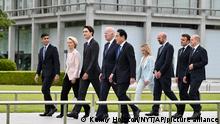 From left, British Prime Minister Rishi Sunak, European Commission President Ursula von der Leyen, Canadian Prime Minister Justin Trudeau, U.S. President Joe Biden, Japan's Prime Minister Fumio Kishida, Italian Premier Giorgia Meloni, European Council President Charles Michel, French President Emmanuel Macron and German Chancellor Olaf Scholz walk to get into place to participate in a wreath laying ceremony at the Peace Memorial Park as part of the G7 Hiroshima Summit in Hiroshima, western Japan Friday, May 19, 2023. (Kenny Holston/Pool Photo via AP)