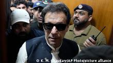 Former Pakistani Prime Minister Imran Khan, center, leaves after appearing in a court, in Lahore, Pakistan, Friday, May 19, 2023. (AP Photo/K.M. Chaudary)Khan dialed down his campaign of defiance on Friday, saying he would allow a police search of his home over allegations that he was harboring suspects wanted in recent violence during anti-government protests by his supporters. (AP Photo/K.M. Chaudary)