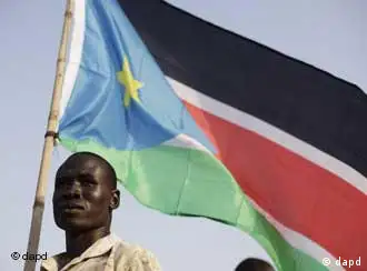 A Bari community member holds the flag of southern Sudan during celebrations on the eve of their declaration of independence in Juba, southern Sudan, Friday, July 8, 2011. Southern Sudan is set to declare independence from the north on Saturday. (Foto:David Azia/AP/dapd)