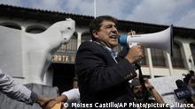Presidential candidate Carlos Pineda of the Prosperidad Ciudadana party speaks into a bullhorn after arriving to the Constitutional Court in Guatemala City, Saturday, May 20, 2023. Pineda seeks to reverse a court decision that has excluded him from the electoral process. (AP Photo/Moises Castillo)