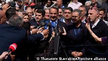 Greece's Prime Minister and leader of New Democracy Kyriakos Mitsotakis talks to the media after votes at a polling station in Athens, Greece, Sunday, May 21, 2023. Polls have opened in Greece's parliamentary election, the first since the country's economy ceased to be subject to strict supervision and control by international lenders who had provided bailout funds during its nearly decade-long financial crisis. (AP Photo/Thanassis Stavrakis)